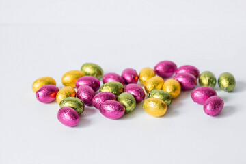A beautiful postcard. Banner. The concept of a bright Easter holiday. Chocolate Easter eggs on a white isolated background. Sweets and sweets.