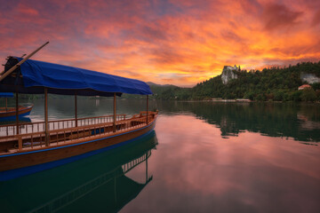 Vew of Lake Bled, Tourist Boat and Bled Castle at Sunset.