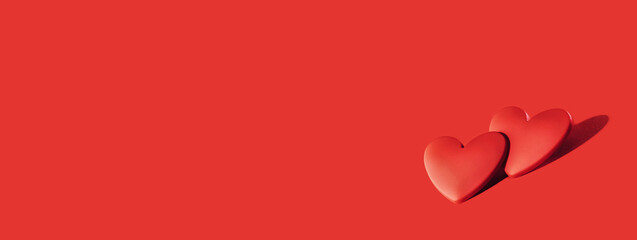 two red hearts on red background. Minimal monochrome for St Valentines day or 14 February. Mothers...