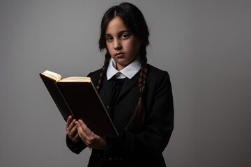 A girl with braids in a gothic style on a dark background.