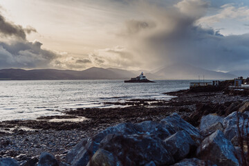 Aerial panorama view of the historic Fenit Lighthouse in Tralee Bay, beautiful clouds, sunset. High quality photo