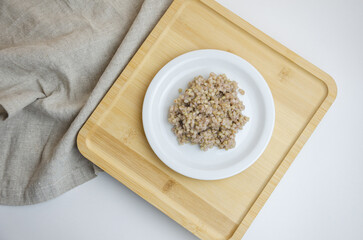 boiled green buckwheat in a plate. healthy food concept