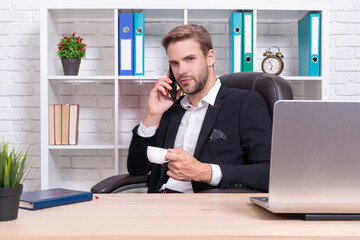 businessman has smartphone talk in studio. businessman has phone talk on background.