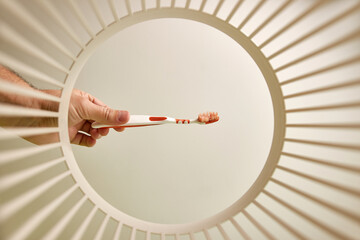 The toothbrush is thrown away for disposal and recycling in the trash. View from below. The concept...