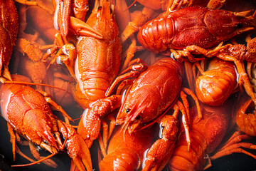 Crayfish are boiled in a pot in water. 