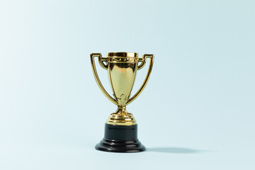 Toy Golden Trophy Cup isolated on cyan background
