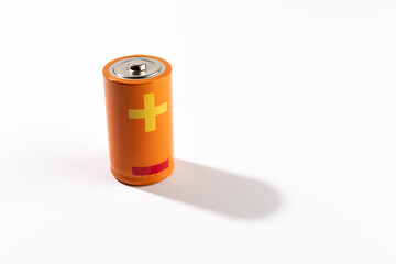 Orange battery on white background, energy concept