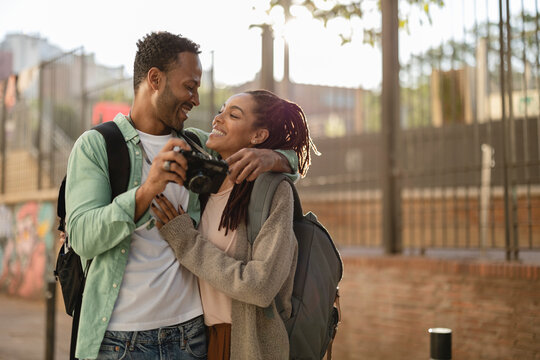 happy couple in love celebrating valentine's day - african americans make photos while traveling in the city