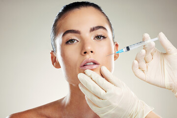 Skincare, collagen and portrait of woman with injection in lips from healthcare professional, anti aging treatment in studio. Beauty, model and aesthetic facial lip filler syringe on background