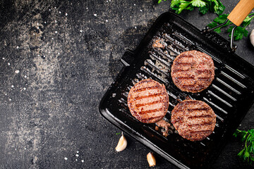 Grilled burger in a frying pan. 
