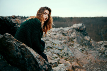Fashionable young girl with messy hair in sweater outdoor