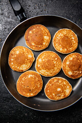 Homemade pancakes in a frying pan. 