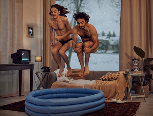 Hipster, rebel and jump into inflatable pool in a lounge inside a retro home or house having fun...