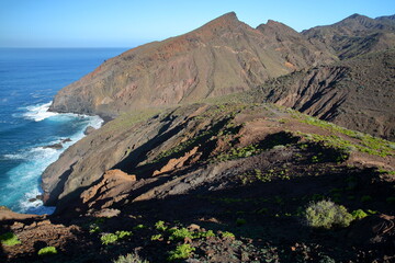 Volcanic and rocky coast near Alojera, La Gomera, Canary Islands, Spain. Picture taken from a hiking trail leading to Playa del Trigo (del Trigo beach) near Alojera in the West of the island