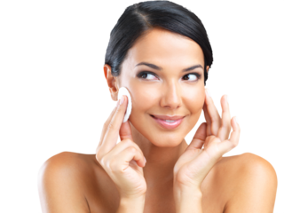 A beautiful young woman holding a makeup pad to her face isolated on a PNG background.