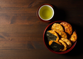 Sembei and green tea on the table. Sembei is a Japanese snack.
