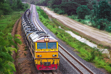 Tanker-freight train by diesel locomotive passed the railway curve.