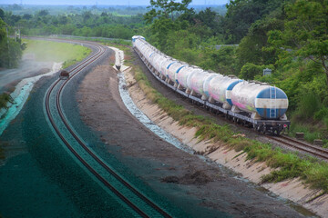 Tanker-freight train by diesel locomotive passed the railway curve.