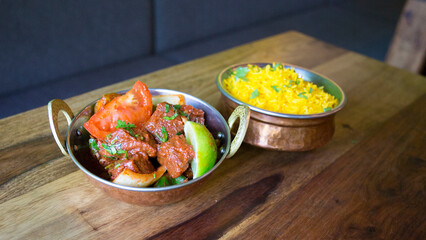 Bowl with vegetables and beef with curry sauce.