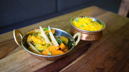 Bowl with vegetables and chicken with curry sauce.