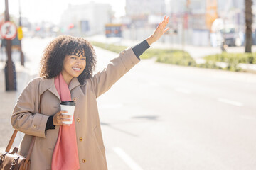 Taxi, coffee and commuting with a business black woman calling or hailing a cab outdoor in the...