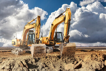 Two large excavator moving stone or soil in a quarry at a construction site. Heavy construction hydraulic equipment. Excavation. © Anoo