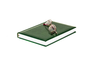 On a white background is a diary and glasses for the eyes