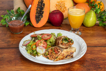 breakfast burritos with salad and orange juice