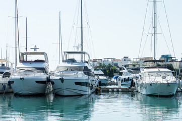 Sailboat harbor,beautiful moored sail yachts in the sea port, modern water transport, summertime vacation, luxury lifestyle and wealth concept