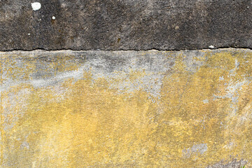 Yellow and black stained concrete wall background and wallpaper texture