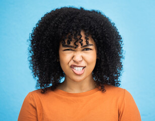 Portrait, emoji and woman with facial expression in studio for fun, relax and playful attitude on blue background. Face, comic and goofy black woman with a funny face, crazy and personality isolated - obrazy, fototapety, plakaty