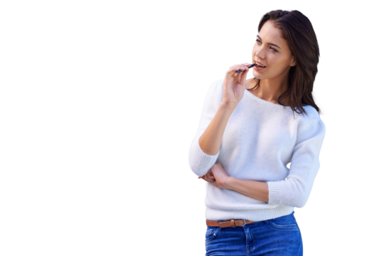 An attractive young woman standing and biting on a pen isolated on a PNG background.