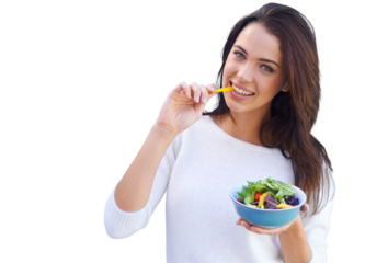 An attractive young woman standing and eating a bowl of salad isolated on a PNG background.