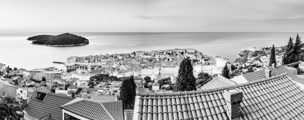 Dubrovnik, Croatia: Panoramic view of the old town on the shores of the Adriatic Sea during sunrise; twilight view of small coastal town on the Croatian Mediterranean riviera