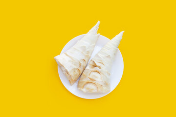 Bamboo shoots on yellow background.