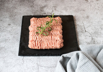 Raw minced meat with herbs and spices. on gray background