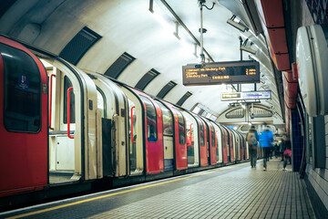 Motion blurred view of London underground platform and tube train - Powered by Adobe