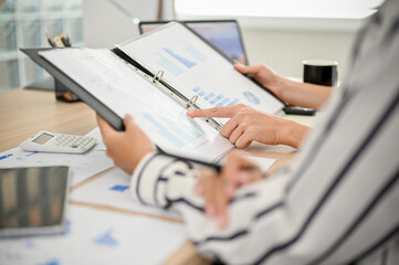 Group of professional businesspeople checking a financial report together in the meeting.