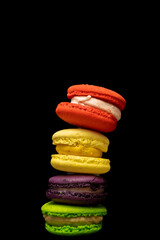 coloured macaroon pastries arranged vertically one on top of the other