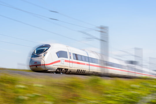 Claye-Souilly, France - July 4, 2022: An ICE high speed train (Velaro D by Siemens) from german rail company Deutsche Bahn (DB) is driving at full speed in the countryside (artist's impression).