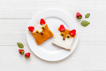 Funny kids sandwich fox face - toast bread with peanut butter and strawberries