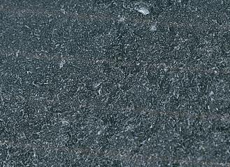 Macro of car glass window covered with ice and snow. Concept of bad visibility during freezing weather conditions.