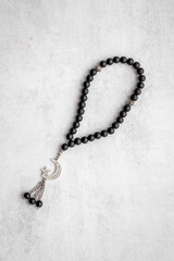 Islamic background with Muslim rosary and silver crescent moon