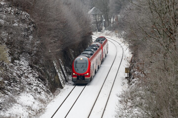 Red railcar on the “Ruhrtalbahn“ (Ruhr valley line) between Arnsberg and Meschede Sauerland...