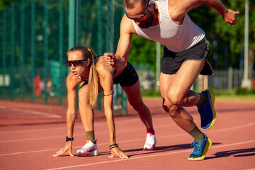 Woman and man jogging in the stadium