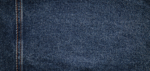 Naklejka premium texture of blue jeans denim fabric with seam background