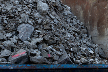 Close up of concrete construction waste rubble in a steel container