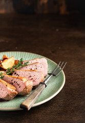 Roast duck breast with potatoes and berry sauce, selective focus, place for text