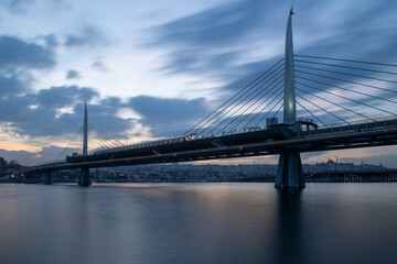 Long exposure. View of Haliç Metro Bridge connecting Azapkapı (Beyoğlu) and Unkapanı (Fatih) (Halic Metro Bridge). blue sky Istanbul Turkey	