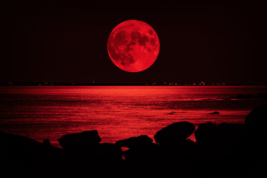 Full red moon over the sea